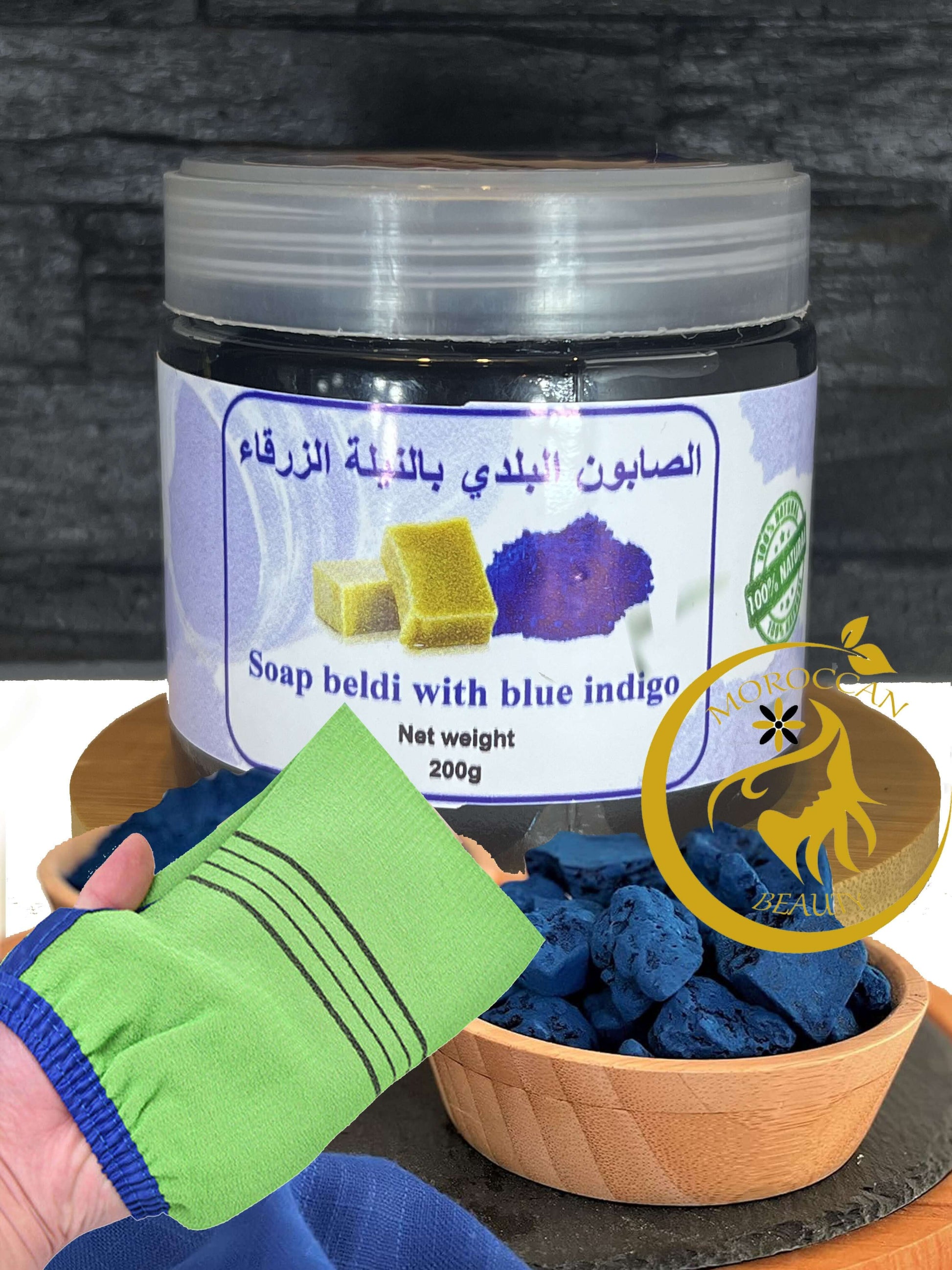 Moroccan black soap with Blue Nila and scrub glove for rejuvenating skincare.